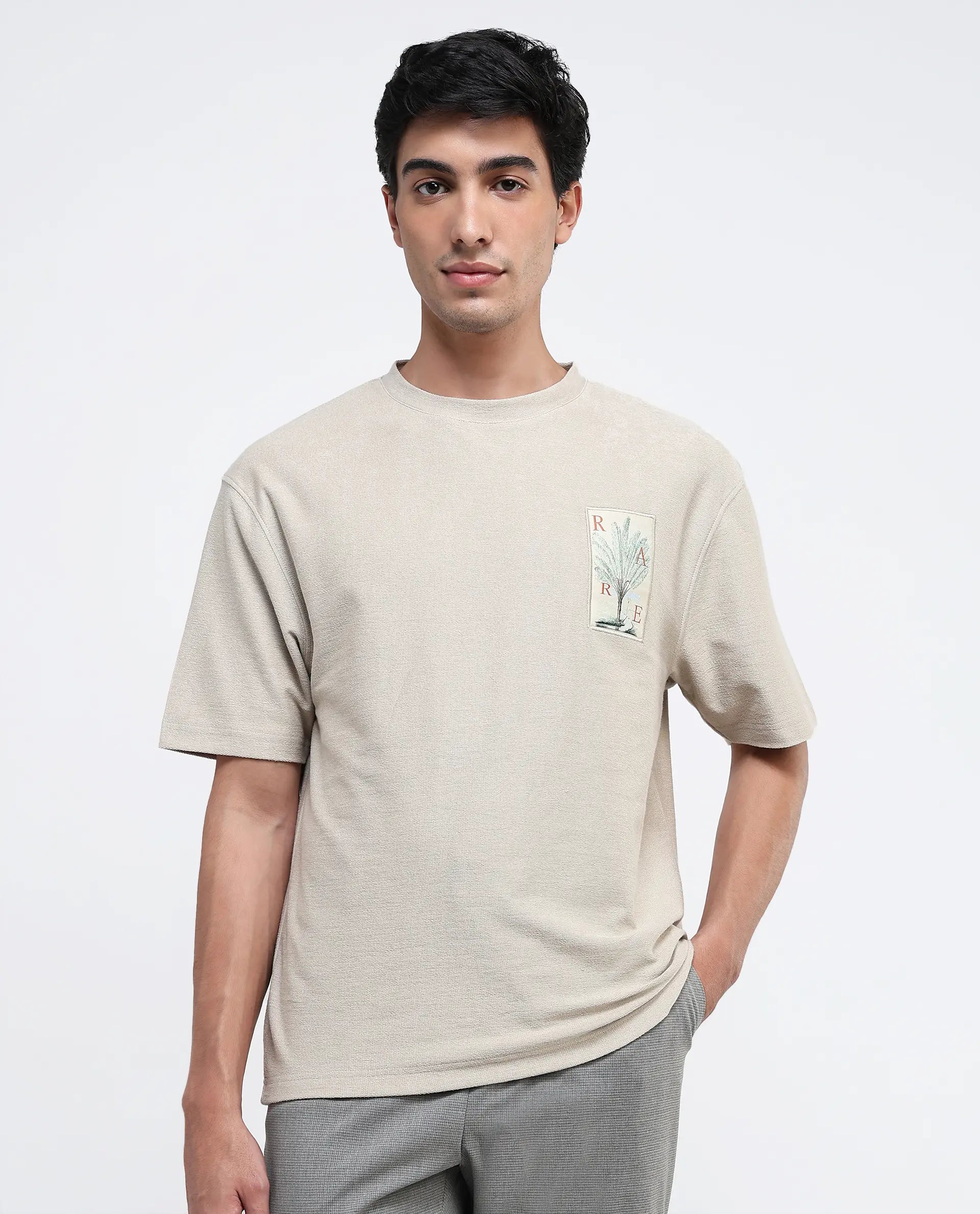 Men's Shirts with Velcro ClosuresRare Rabbit Men's Loopet Beige Cotton Lycra Fabric Half Sleeves Floral Print Pocket Detailing Oversized Fit Solid T-Shirt