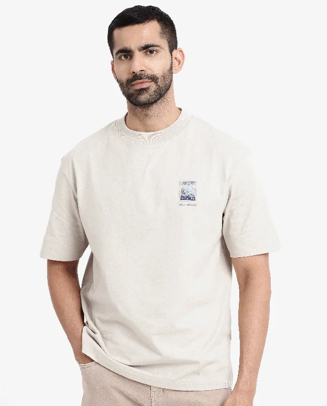 Men's Shirts with Belt AttachmentsRare Rabbit Men Trams Beige Cotton Fabric Short Sleeve Crew Neck Oversized Fit Graphic Print T-Shirt